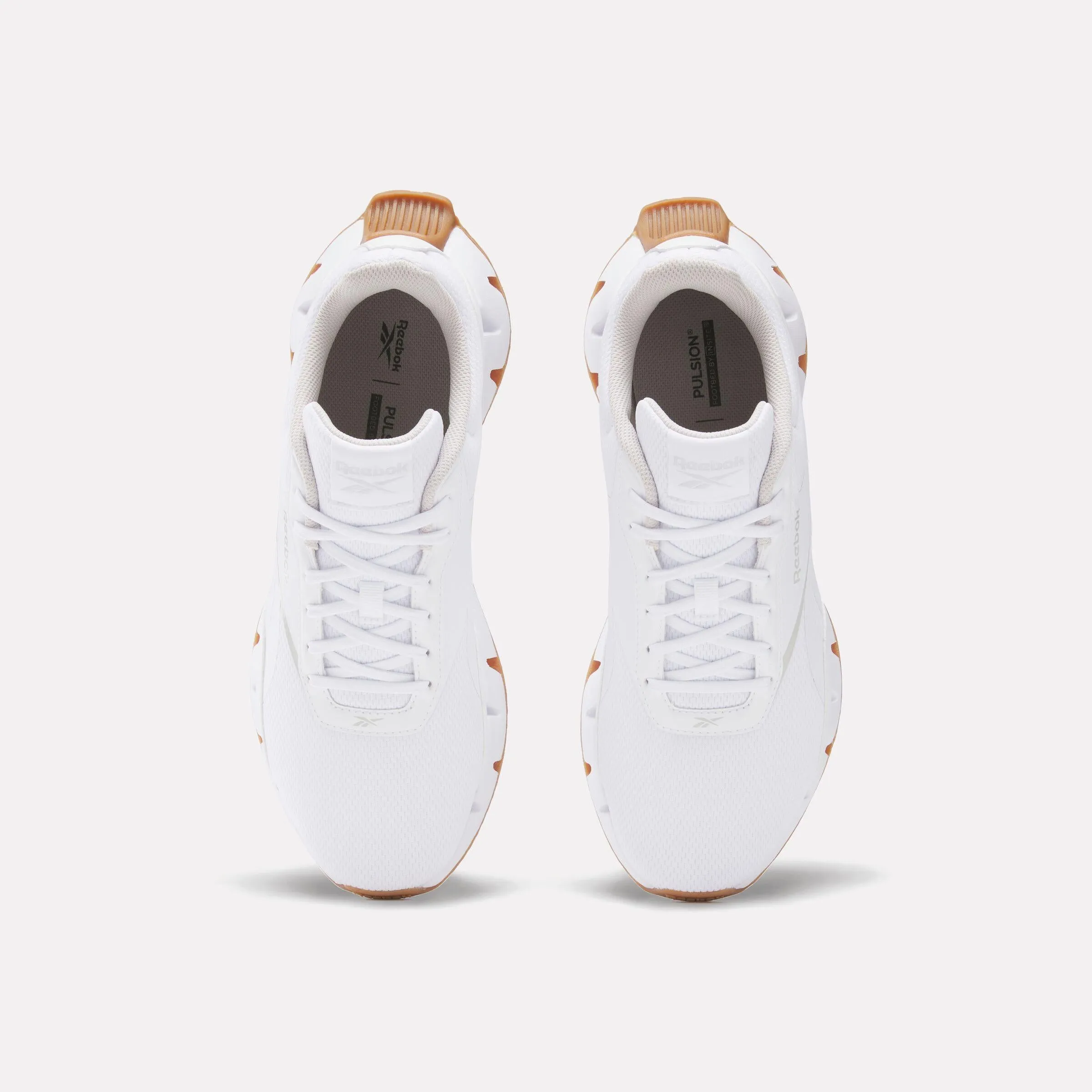 Reebok Footwear Men Zig Dynamica STR Shoes WHITE/WHITE/WHITE running on a synthetic track shoes
