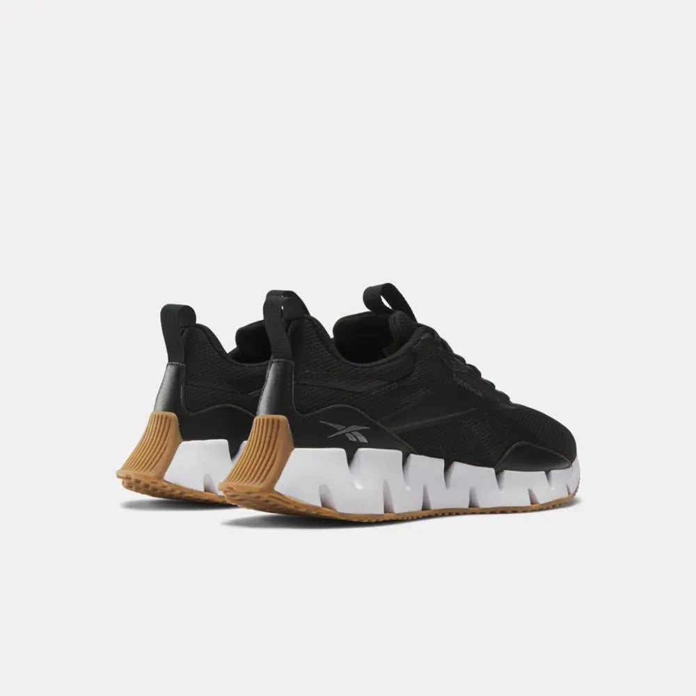 Reebok Footwear Women Zig Dynamica STR Shoes CBLACK/FTWWHT/SILVMT running in a subway station area shoes adventure - shoes